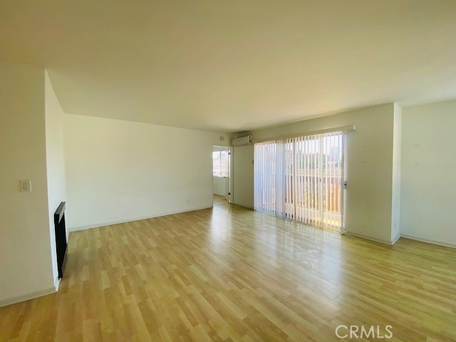 811 6th Street, Unit 305 Santa Monica, CA 90403 - Photo 5 of 25 a view of an empty room with wooden floor and a window