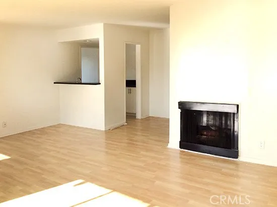 a view of an empty room and window and fire place