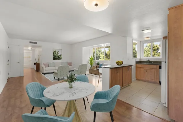 a view of a dining room with furniture and a window