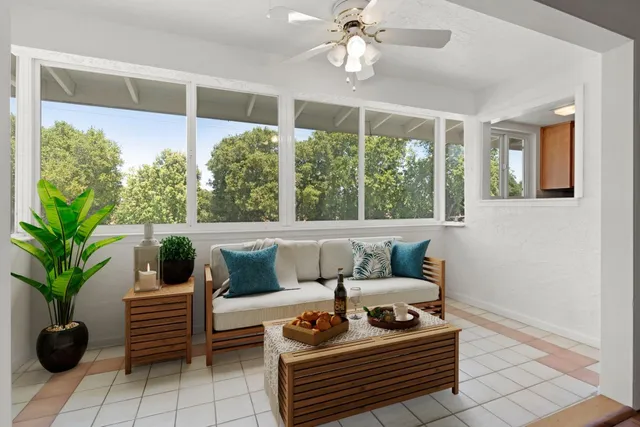 a living room with furniture and a potted plant