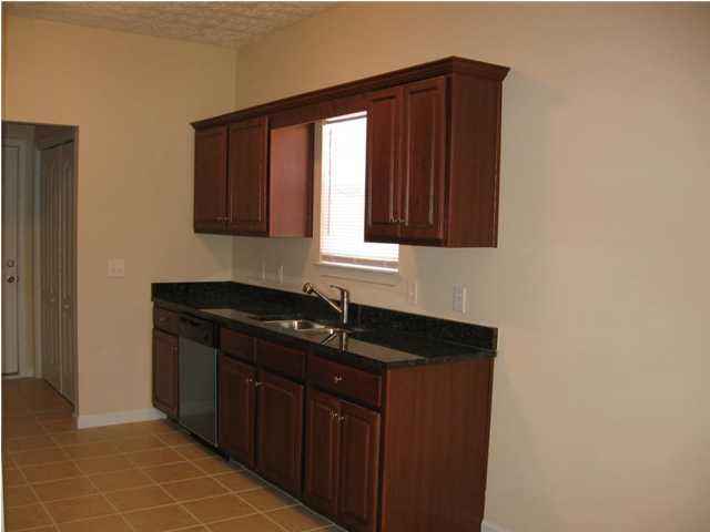 601 Tropical Way Freeport, FL 32439 - Photo 11 of 17 a kitchen with a sink and cabinets