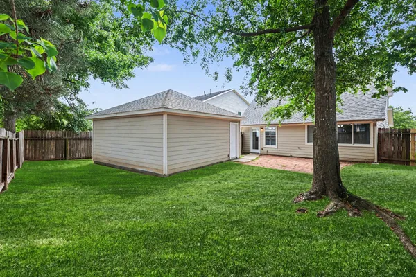 a view of a house with a backyard