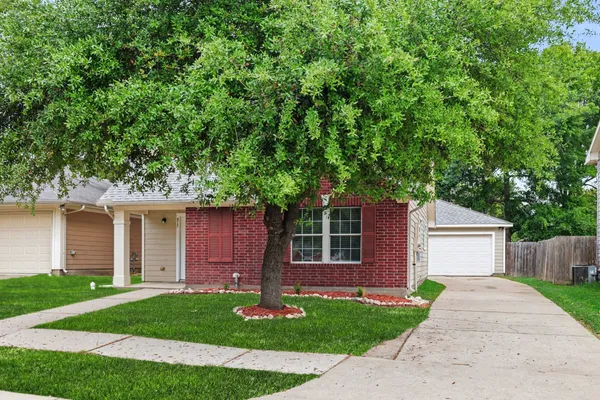 a front view of a house with a garden and yard
