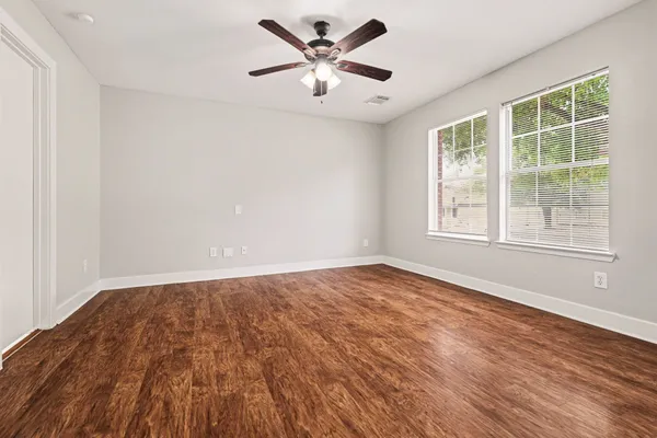 wooden floor in an empty room with a window