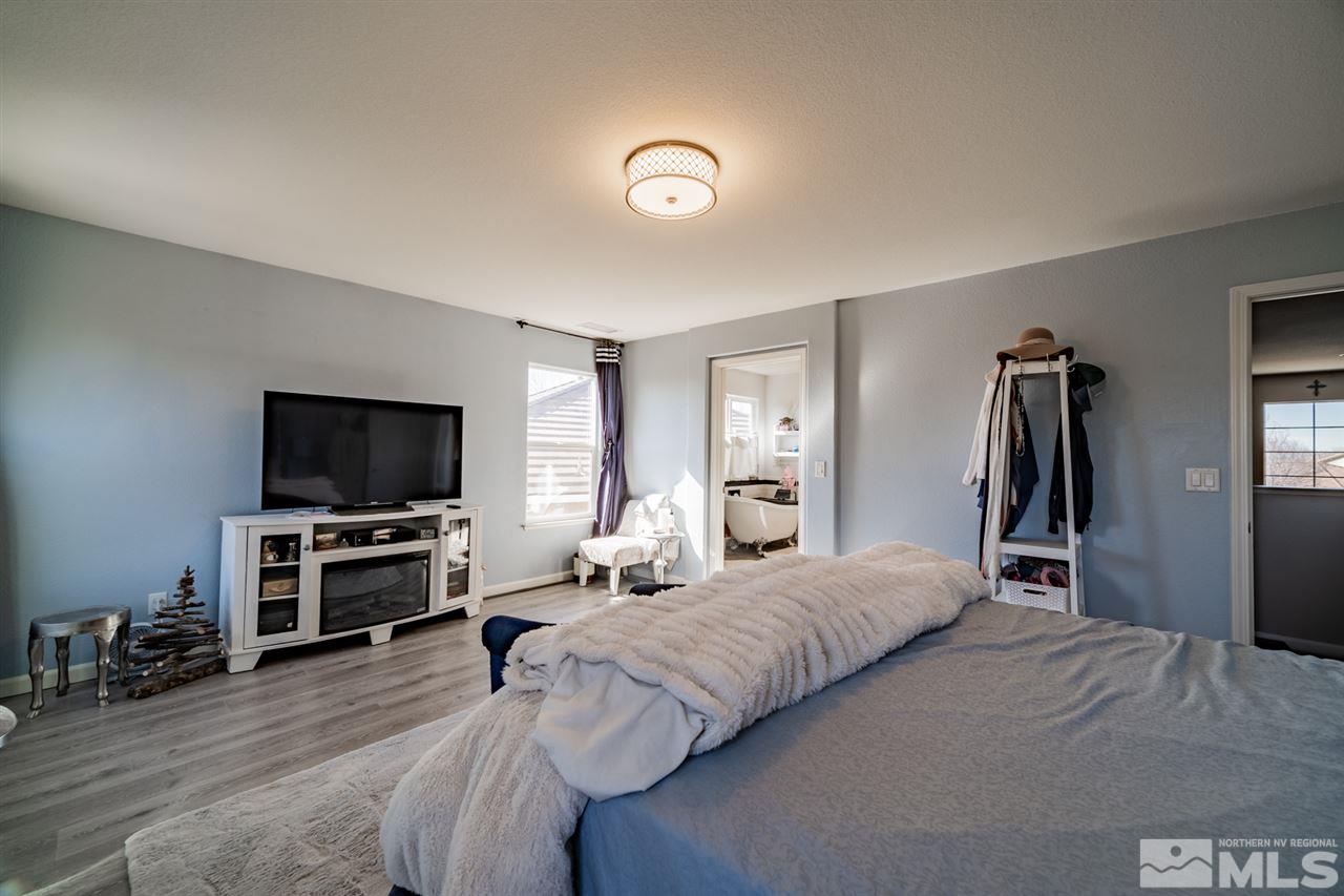 11398 Parma Court Reno, NV 89521 - Photo 25 of 39 a bedroom with a bed and a flat screen tv