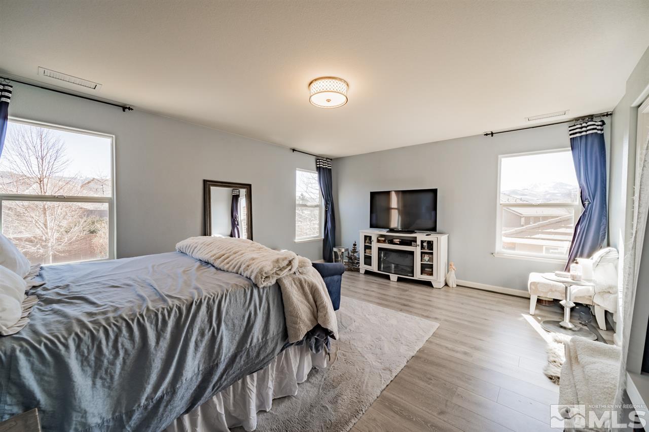 11398 Parma Court Reno, NV 89521 - Photo 26 of 39 a bedroom with a bed and a television in it