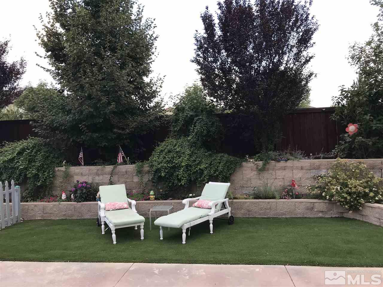 11398 Parma Court Reno, NV 89521 - Photo 37 of 39 a view of a white house with a yard and sitting area
