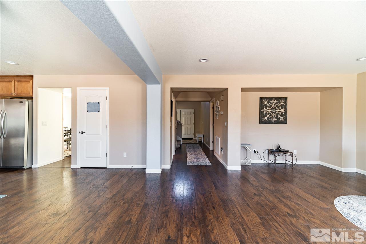 11398 Parma Court Reno, NV 89521 - Photo 8 of 39 a view of a hallway with wooden floor and a bathroom
