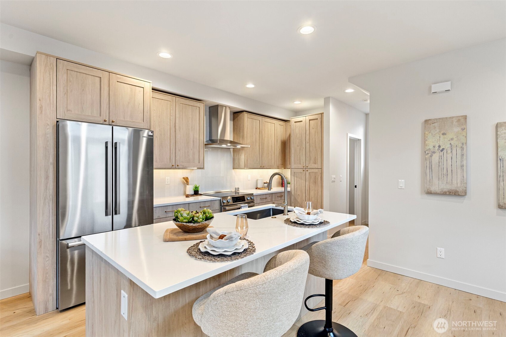 926 Northwest 57th Street, Unit B Seattle, WA 98107 - Photo 18 of 37 a kitchen with refrigerator and chairs