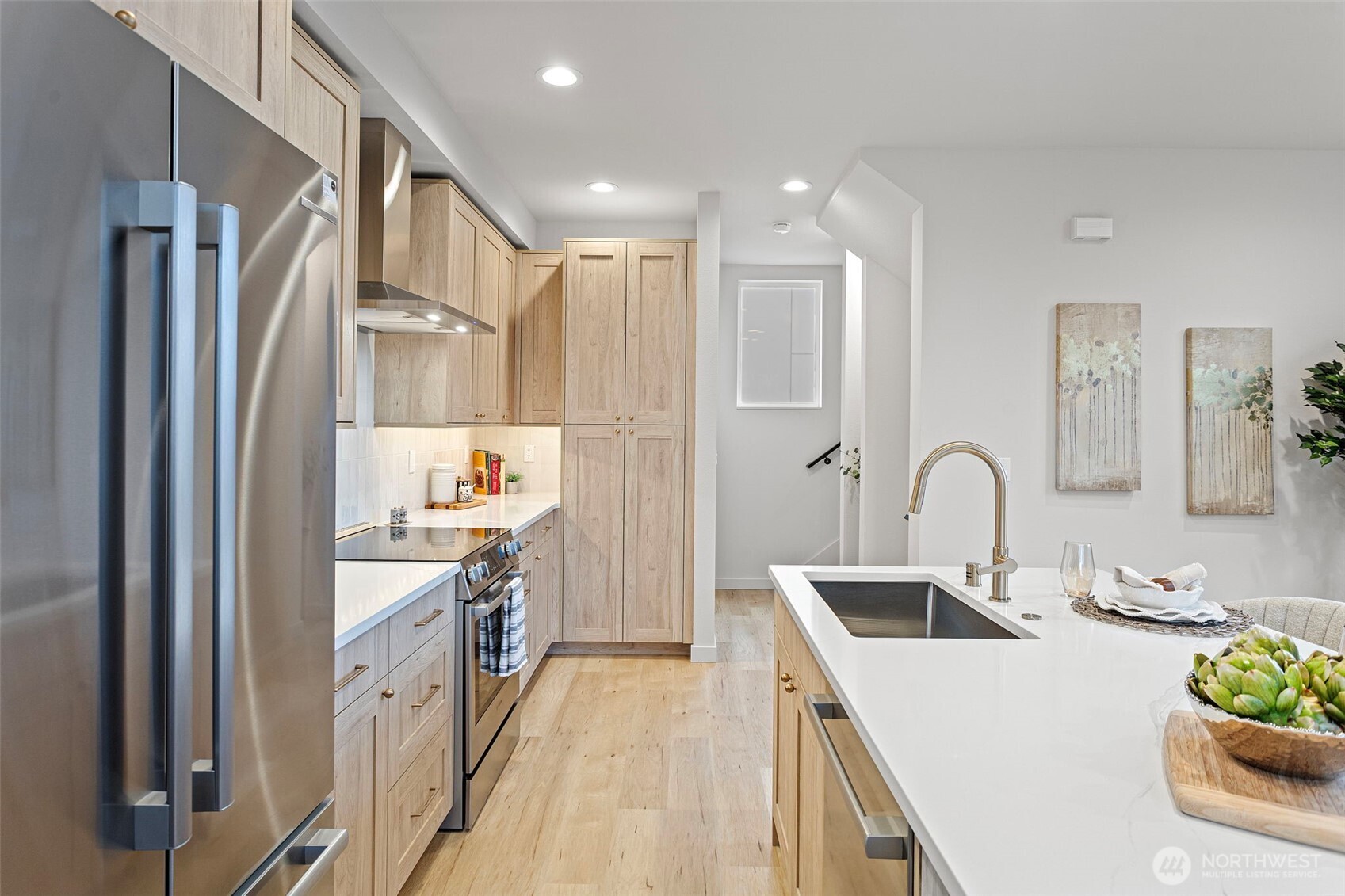 926 Northwest 57th Street, Unit B Seattle, WA 98107 - Photo 20 of 37 a kitchen with white cabinets appliances and sink
