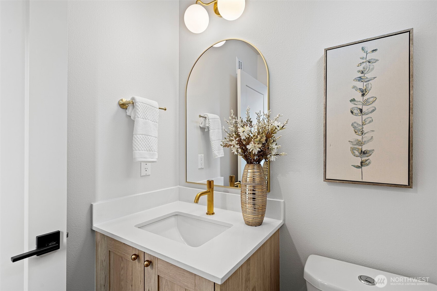 926 Northwest 57th Street, Unit B Seattle, WA 98107 - Photo 24 of 37 a bathroom with a toilet sink and mirror