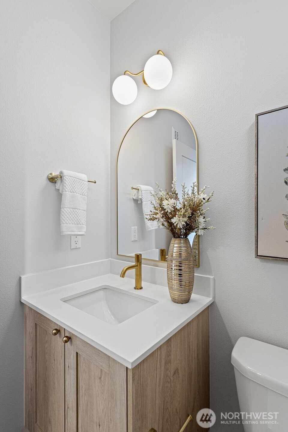 926 Northwest 57th Street, Unit B Seattle, WA 98107 - Photo 25 of 37 a bathroom with a sink a toilet and mirror
