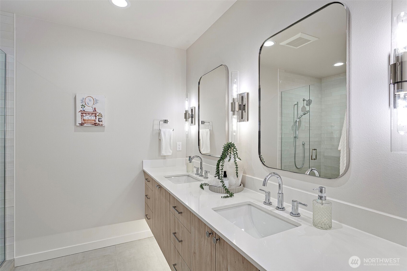 926 Northwest 57th Street, Unit B Seattle, WA 98107 - Photo 29 of 37 a bathroom with double vanity sinks and a mirror
