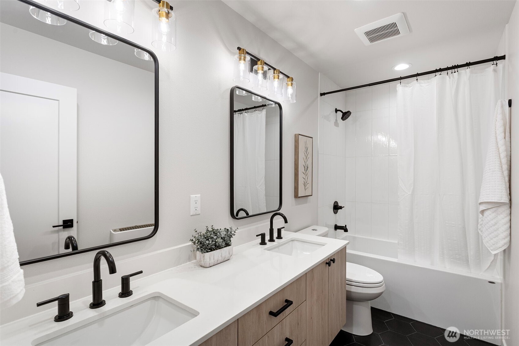 926 Northwest 57th Street, Unit B Seattle, WA 98107 - Photo 7 of 37 a bathroom with double vanity sink a toilet and a mirror
