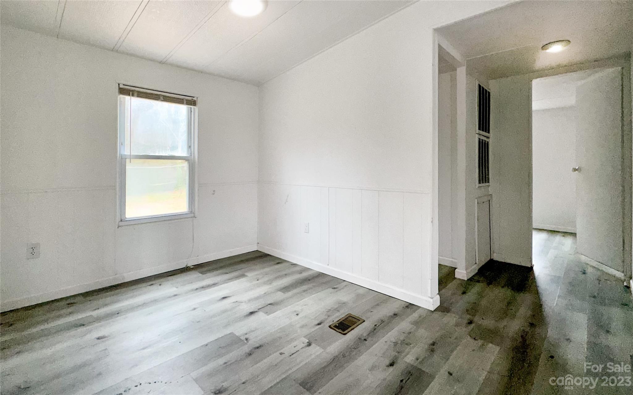 3378 Startown Road Newton, NC 28658 - Photo 11 of 30 an empty room with wooden floor and windows