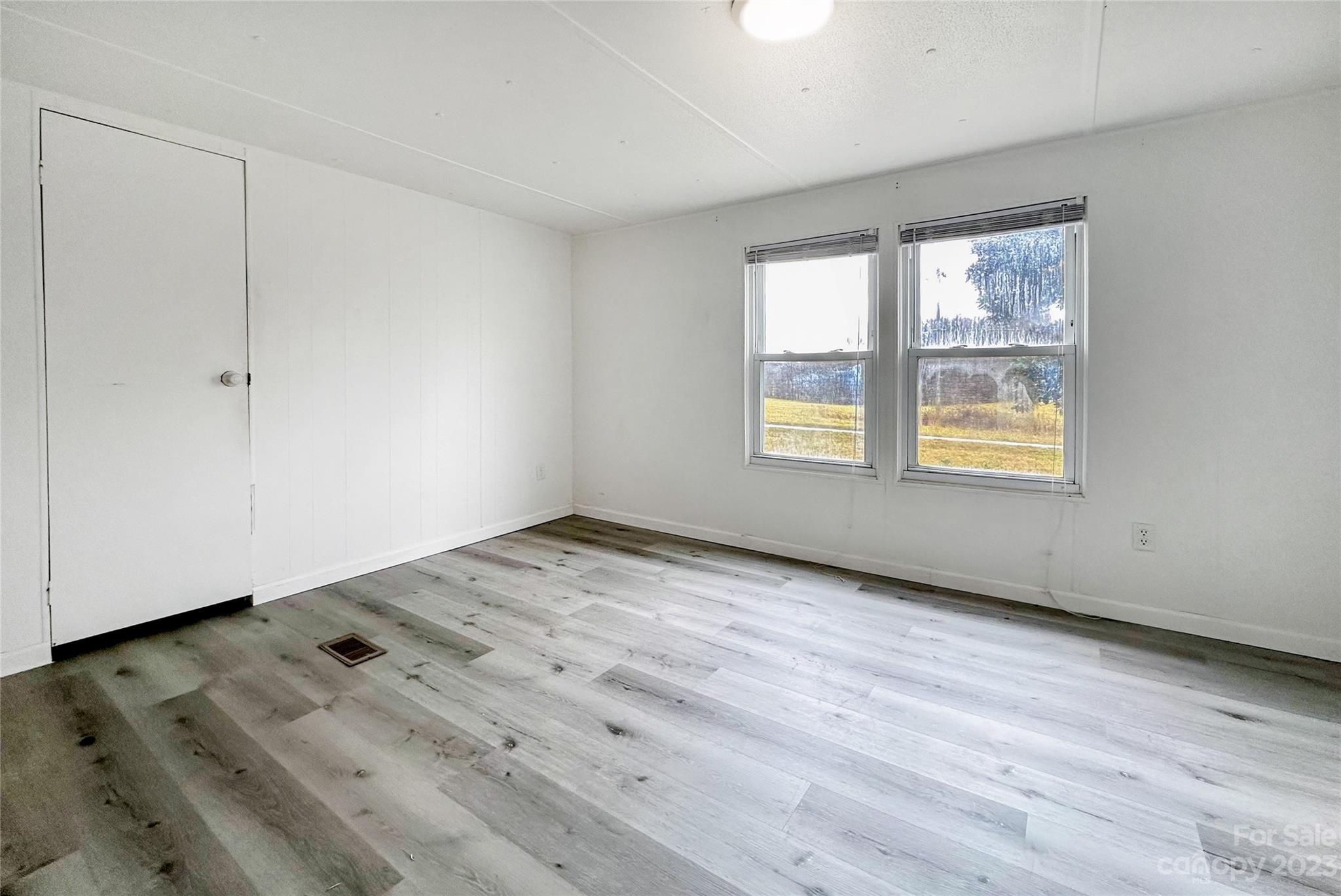 3378 Startown Road Newton, NC 28658 - Photo 12 of 30 a view of an empty room with wooden floor and a window