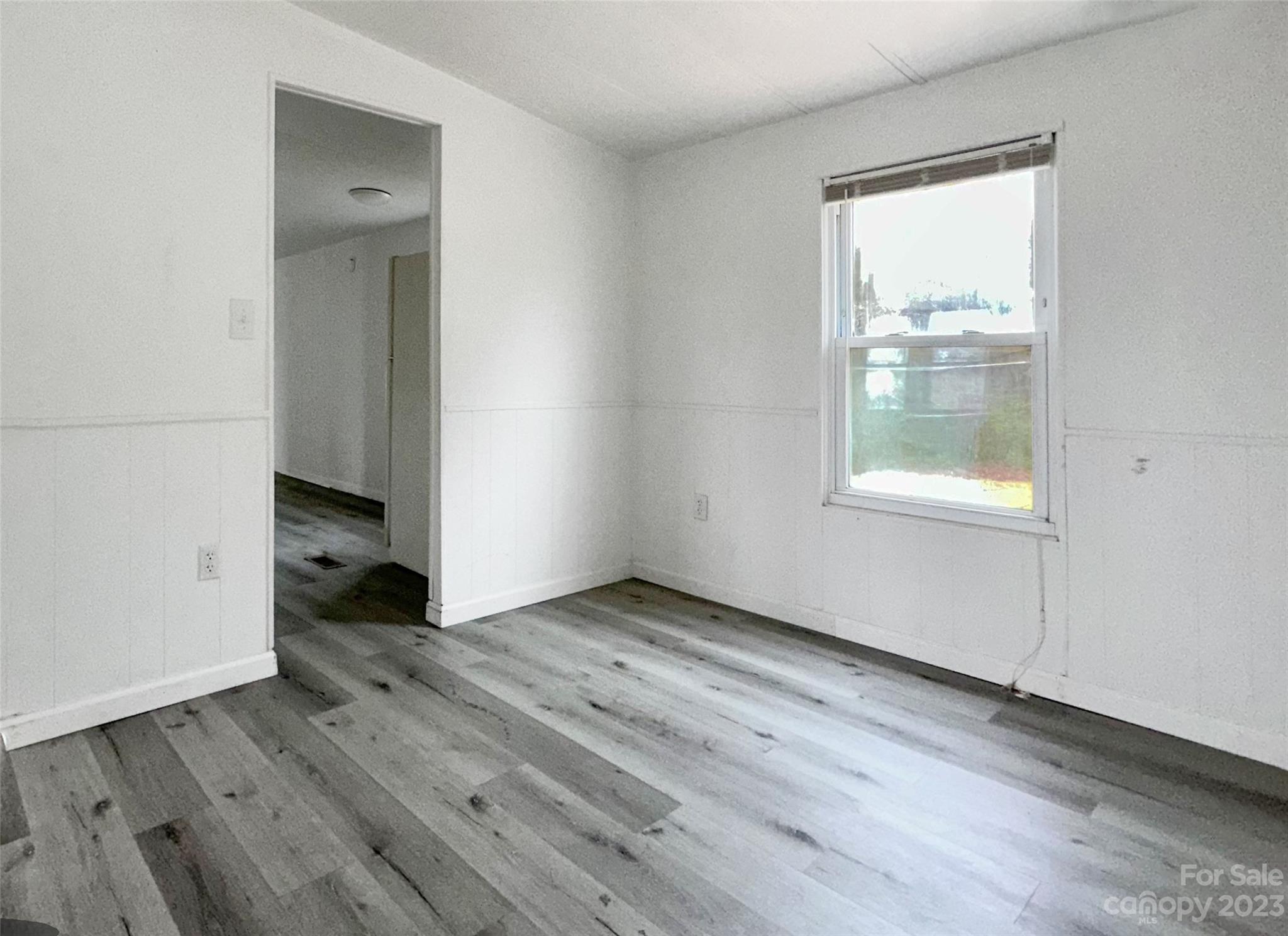 3378 Startown Road Newton, NC 28658 - Photo 19 of 30 an empty room with wooden floor and a window