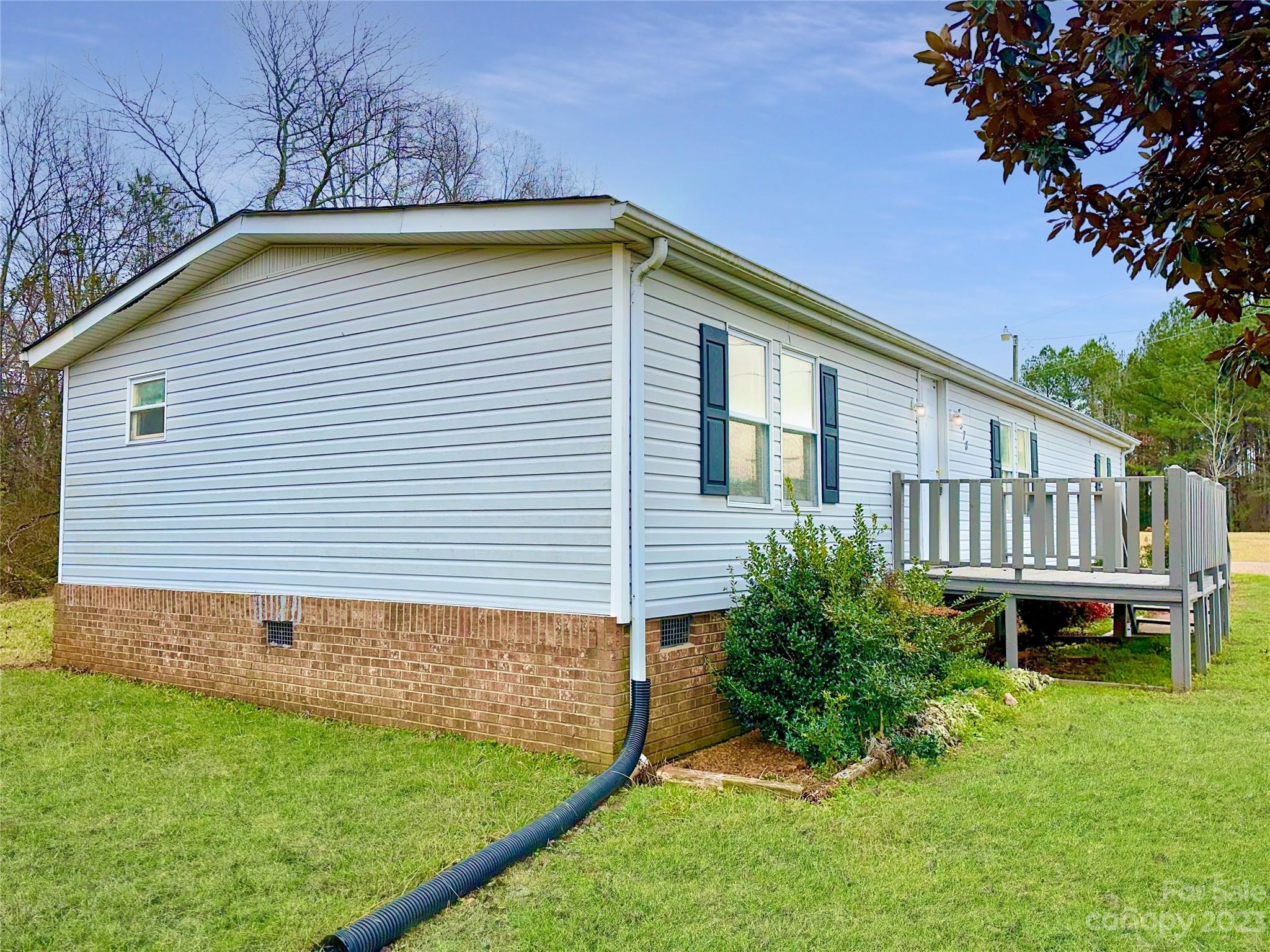3378 Startown Road Newton, NC 28658 - Photo 28 of 30 a view of a backyard with plants and a patio