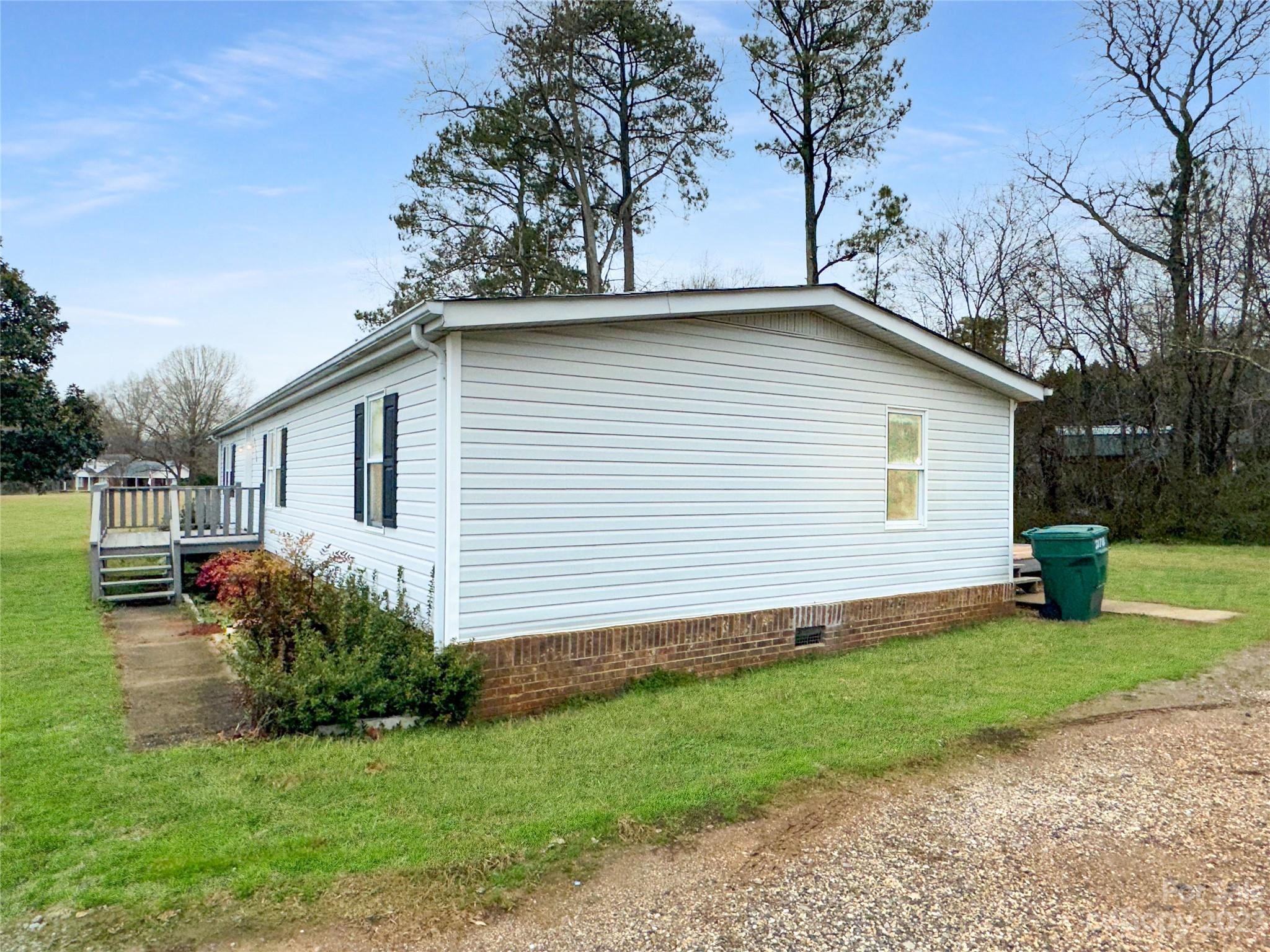 3378 Startown Road Newton, NC 28658 - Photo 29 of 30 a small white house with a yard and large trees