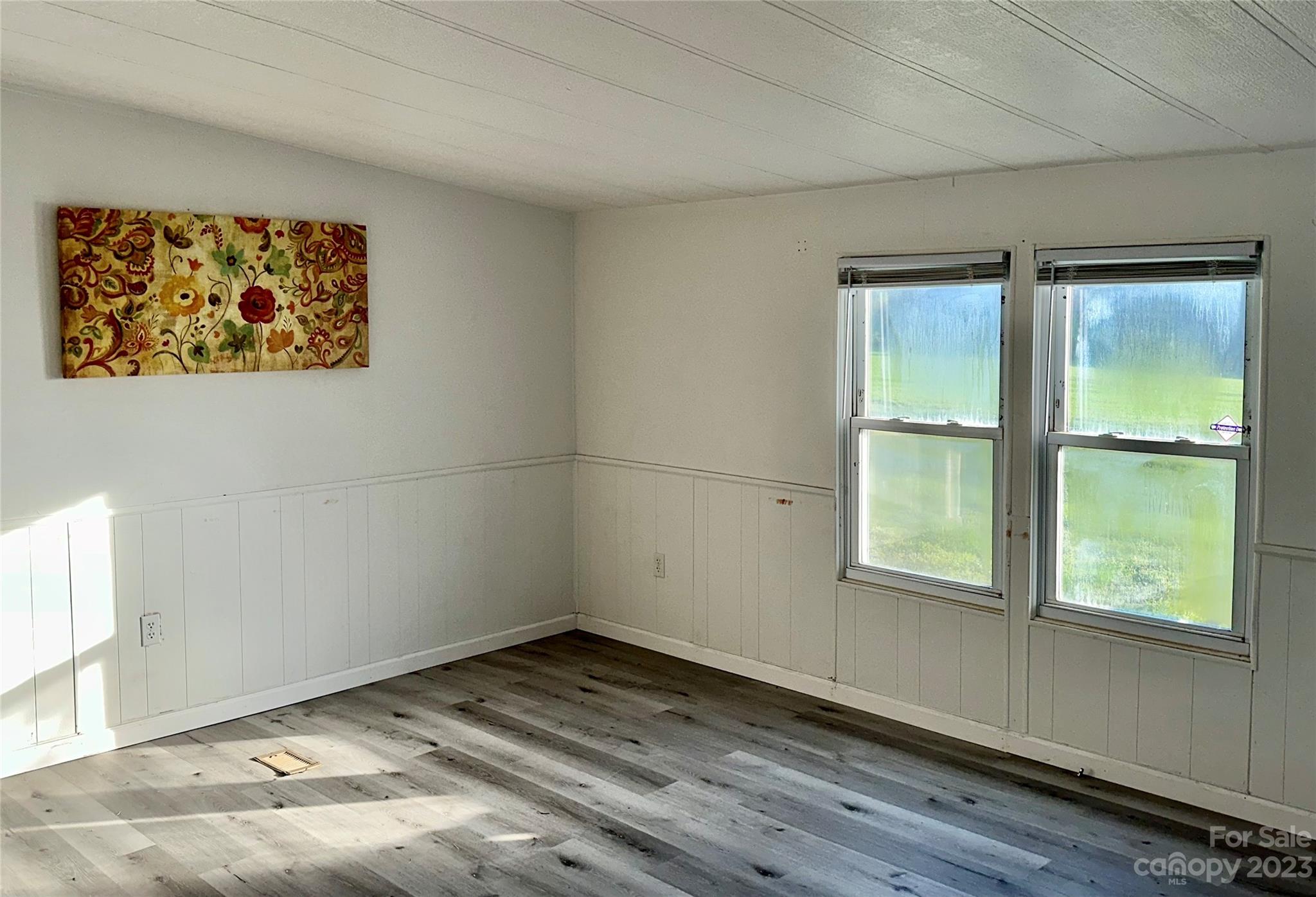 3378 Startown Road Newton, NC 28658 - Photo 4 of 30 an empty room with wooden floor and windows