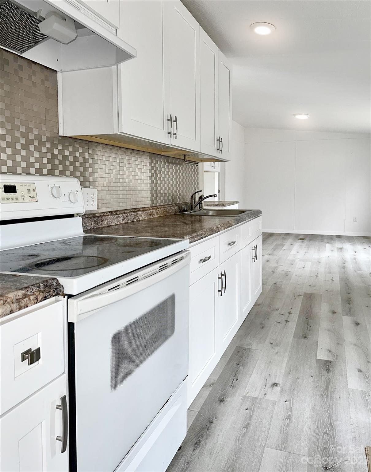 3378 Startown Road Newton, NC 28658 - Photo 9 of 30 a kitchen with granite countertop white cabinets and white appliances