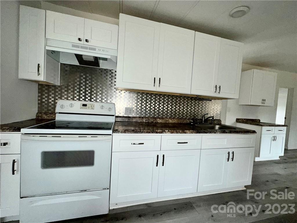 3378 Startown Road Newton, NC 28658 - Photo 10 of 30 a kitchen with white cabinets and white appliances