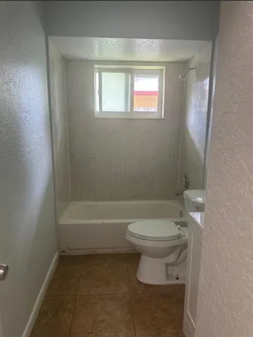 a bathroom with a toilet a sink and bathtub