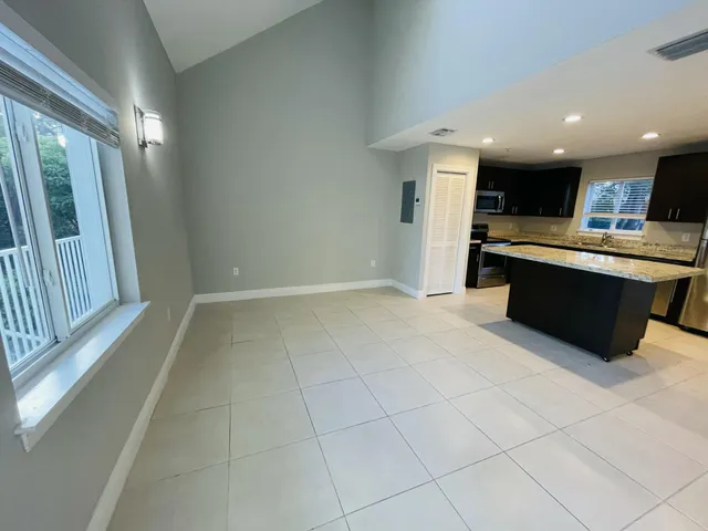 a kitchen with kitchen island a sink stainless steel appliances and counter space