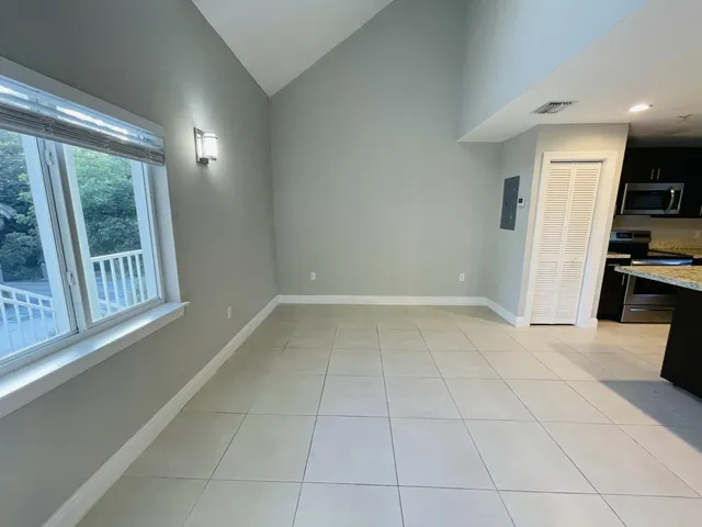 a kitchen with kitchen island a stove a refrigerator and a sink