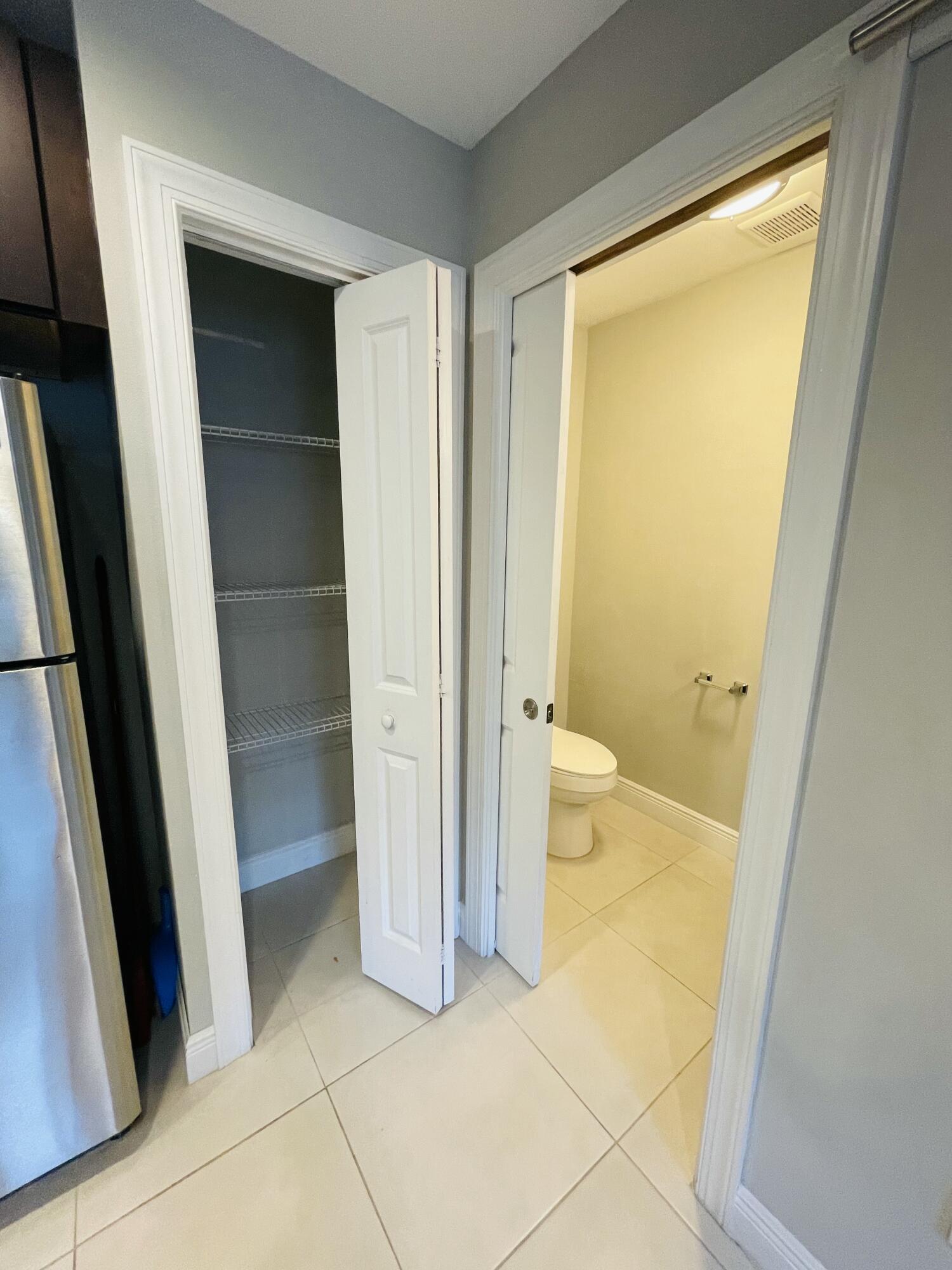 102940 Overseas Highway, Unit 2 Key Largo, FL 33037 - Photo 28 of 39 a bathroom with a sink and a glass door shower