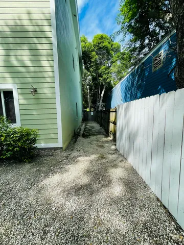 a view of a house with backyard and trees