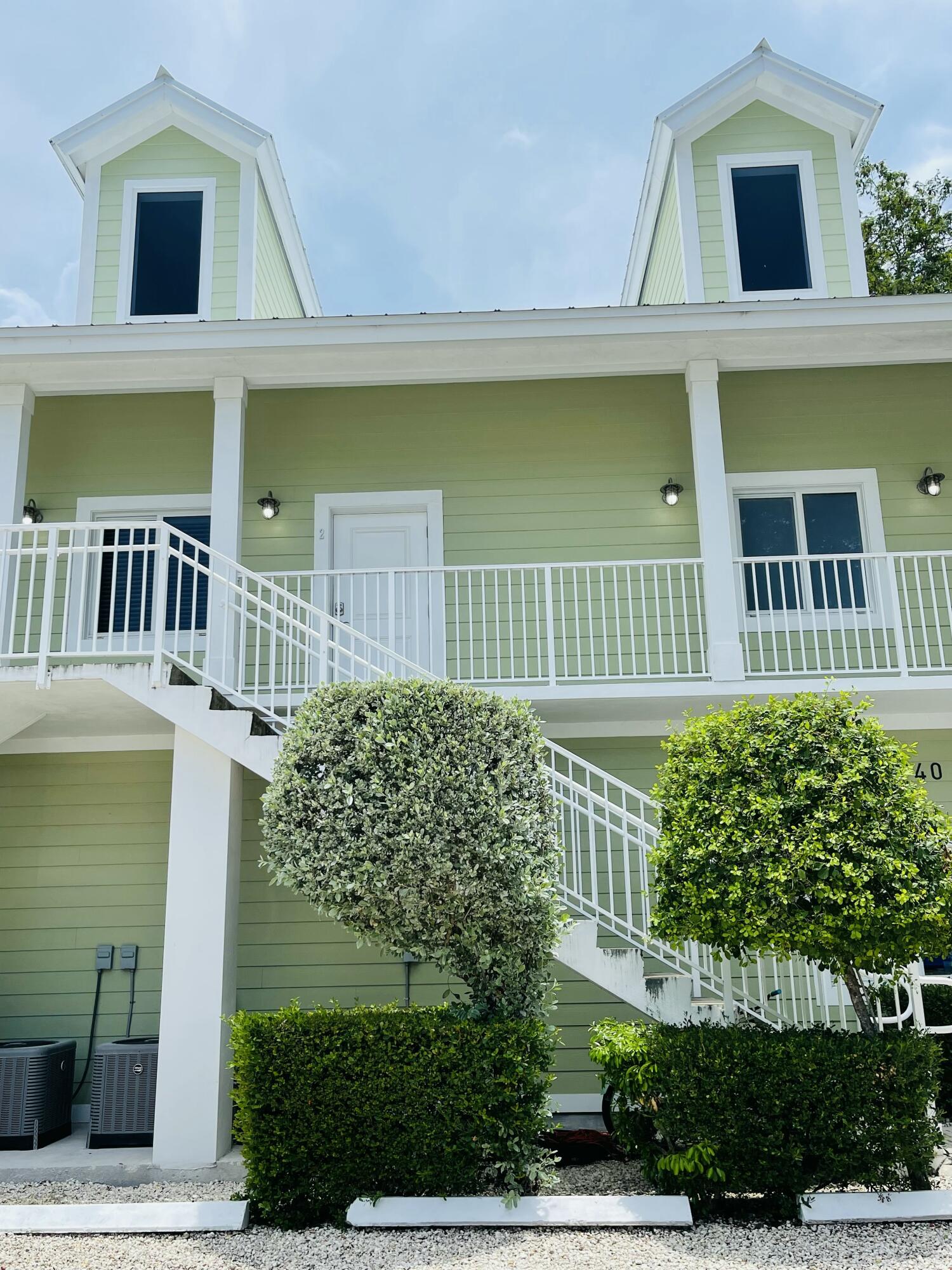 102940 Overseas Highway, Unit 2 Key Largo, FL 33037 - Photo 7 of 39 a view of a brick house with a large window