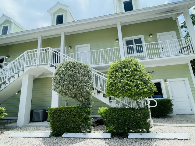 a view of a porch with wooden floor and fence