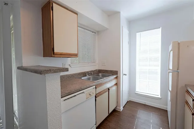 a kitchen with white cabinets and a stove