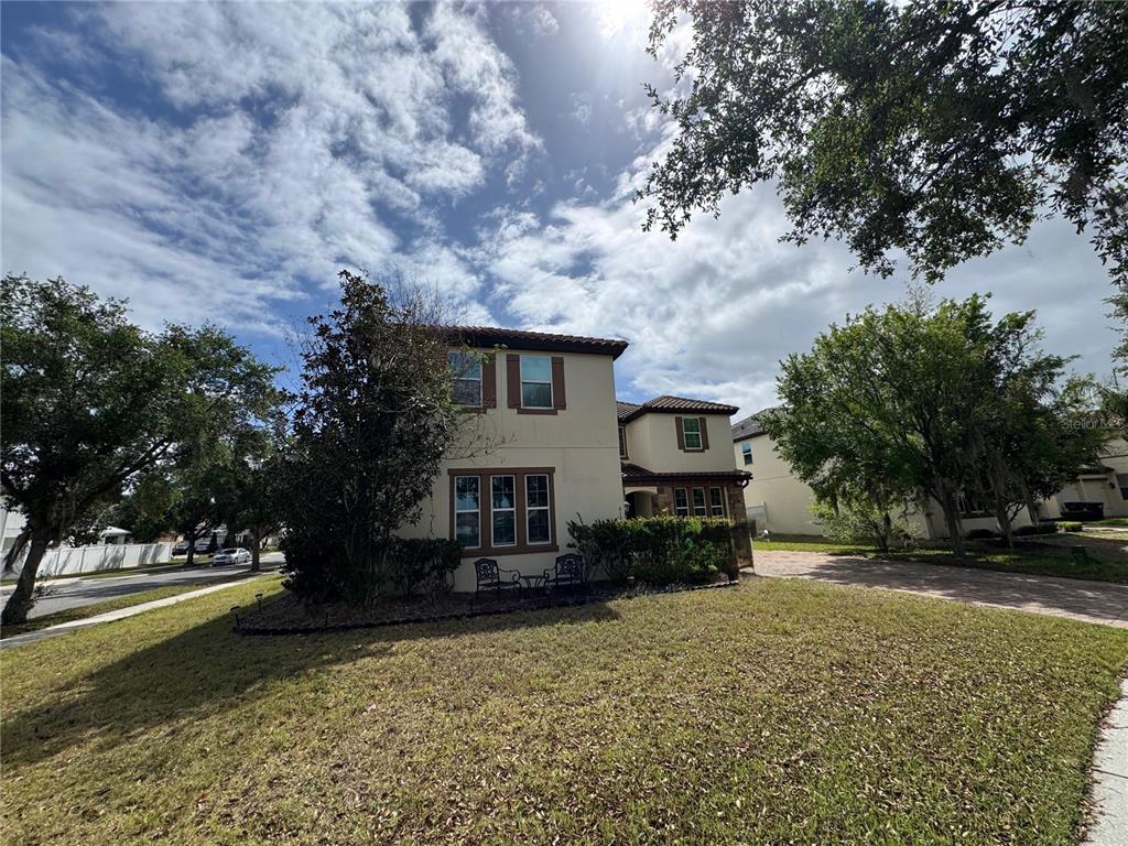 6152 Golden Dewdrop Trail Windermere, FL 34786 - Photo 2 of 3 a front view of a house with a yard and trees