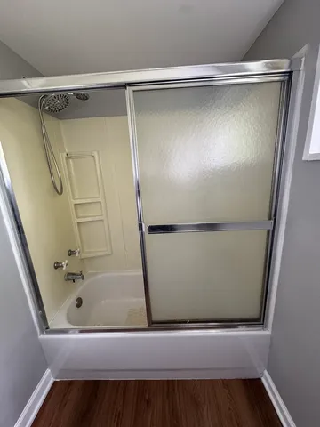 a bathroom with a glass shower door and a sink