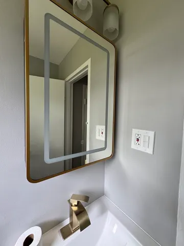 a bathroom with a sink and a mirror