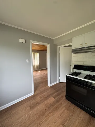 a view of an empty room and wooden floor