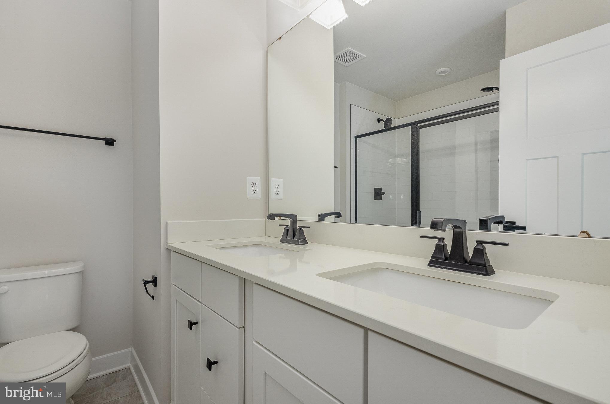 1002 Alum Spring Road Fredericksburg, VA 22401 - Photo 14 of 23 a bathroom with a sink a toilet and a mirror