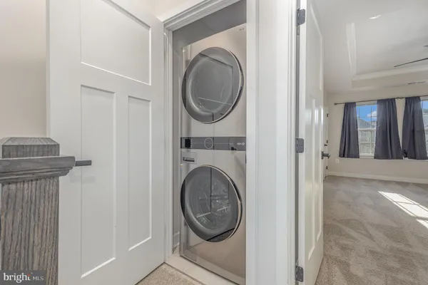 a view of a hallway with washer and dryer
