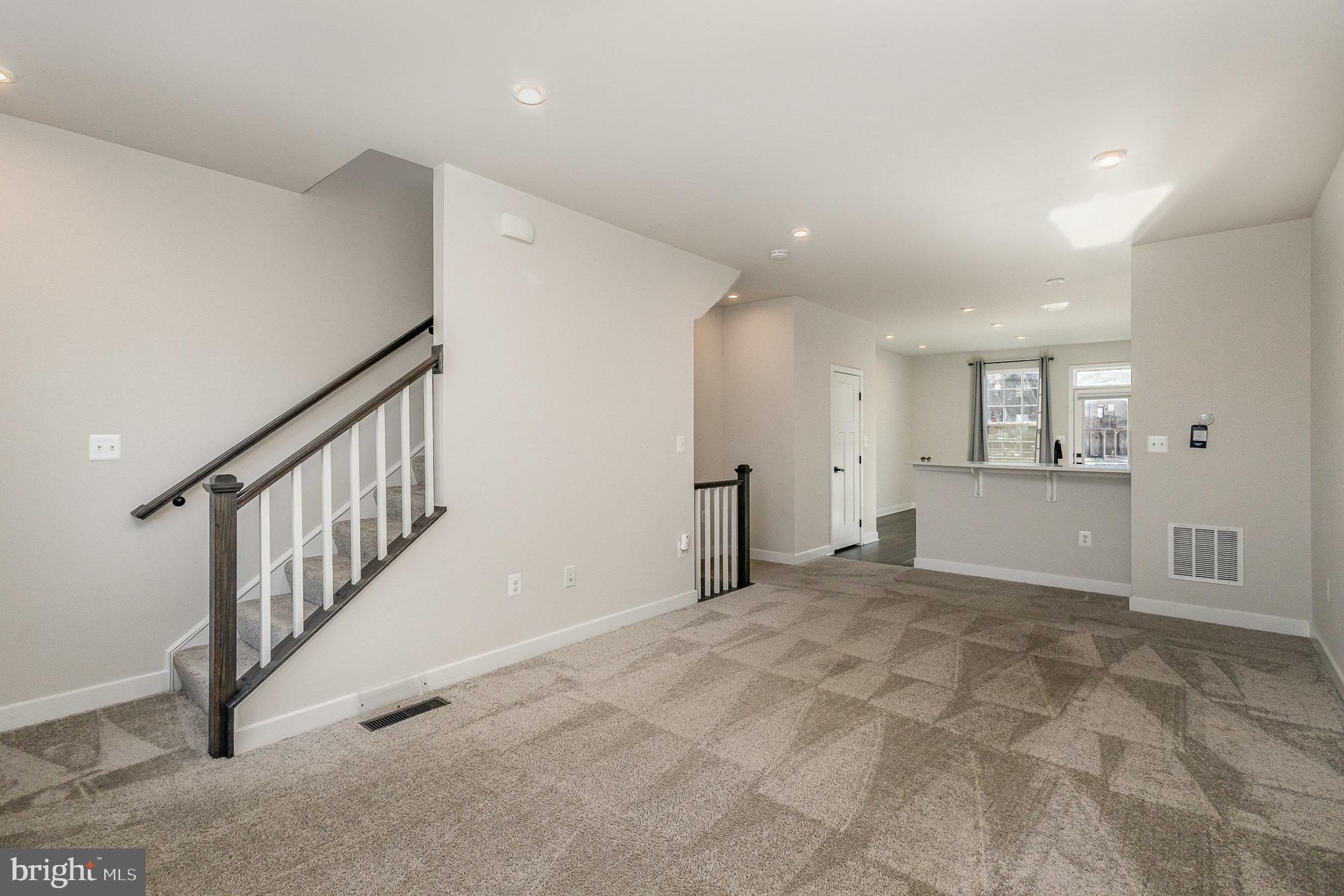 1002 Alum Spring Road Fredericksburg, VA 22401 - Photo 3 of 23 a view of an empty room with wooden floor and stairs