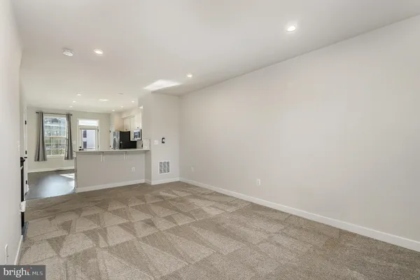 an empty room with cabinet and mirrors