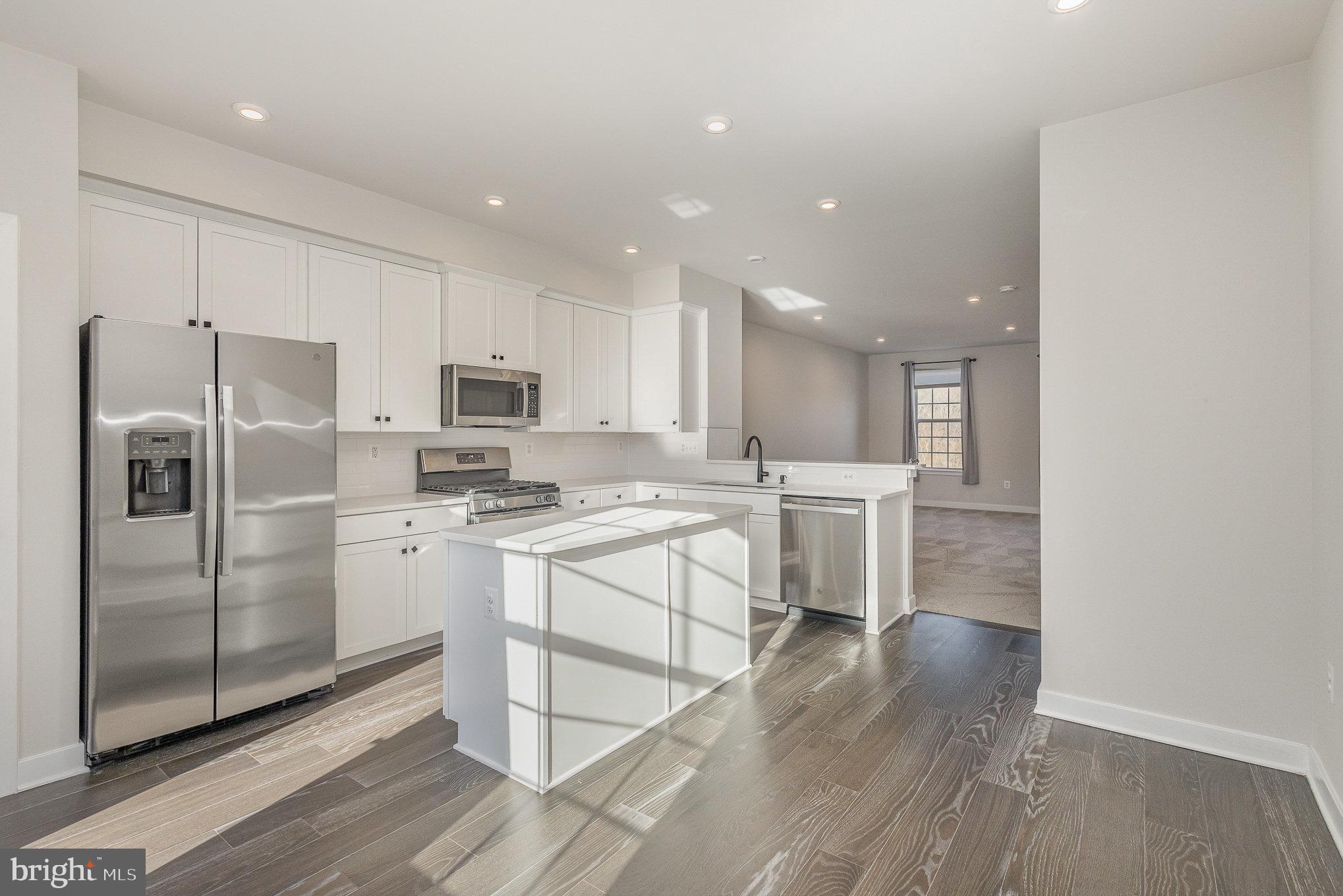 1002 Alum Spring Road Fredericksburg, VA 22401 - Photo 6 of 23 a kitchen with white cabinets and stainless steel appliances