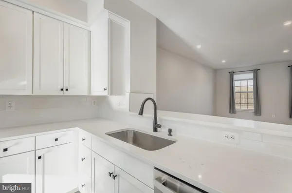 a kitchen with a sink cabinets and window