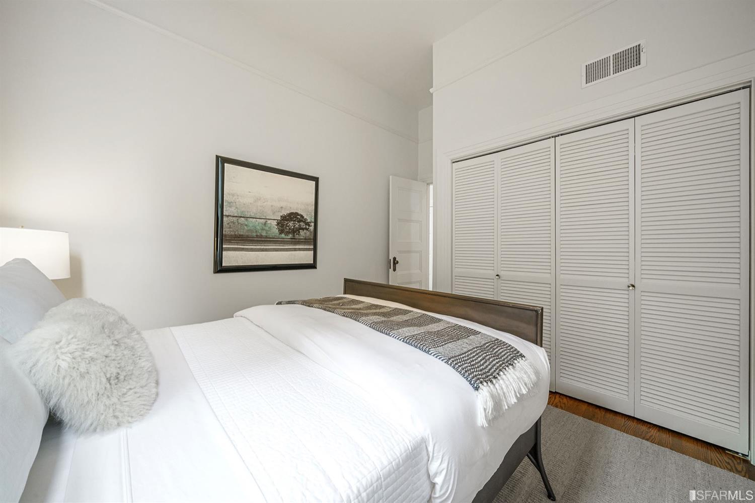 617 Broderick Street, Unit B San Francisco, CA 94117 - Photo 11 of 36 a bedroom with a bed and a painting on the wall