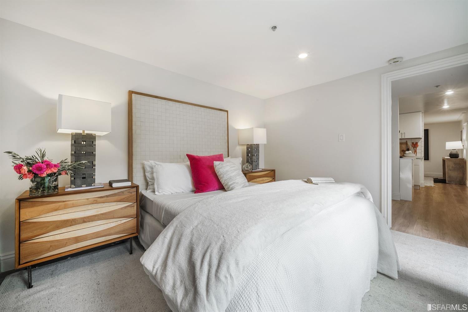 617 Broderick Street, Unit B San Francisco, CA 94117 - Photo 28 of 36 a bedroom with a bed and a chandelier