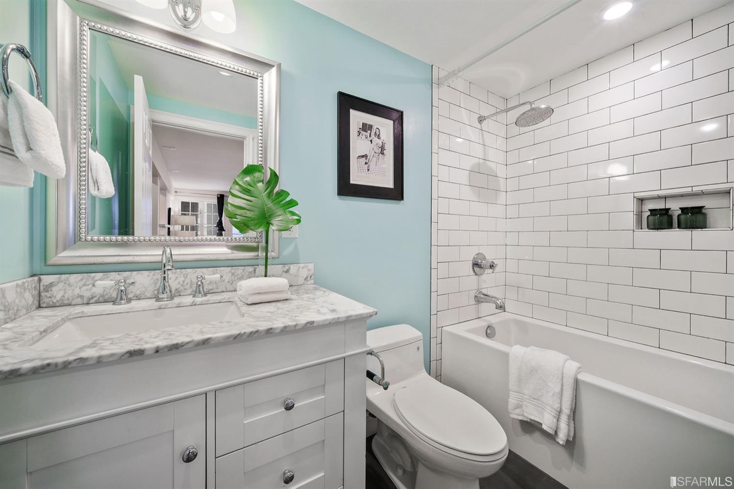 617 Broderick Street, Unit B San Francisco, CA 94117 - Photo 29 of 36 a bathroom with a granite countertop toilet sink and mirror