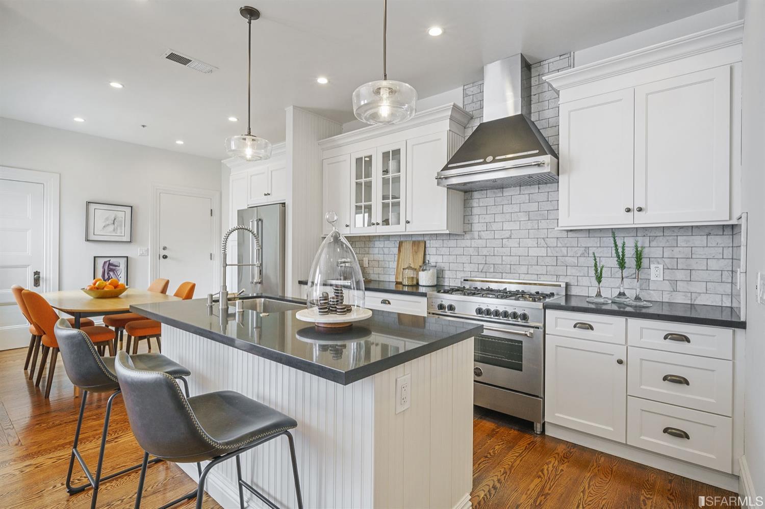 617 Broderick Street, Unit B San Francisco, CA 94117 - Photo 6 of 36 a kitchen with stainless steel appliances granite countertop a stove a sink dishwasher and white cabinets with wooden floor