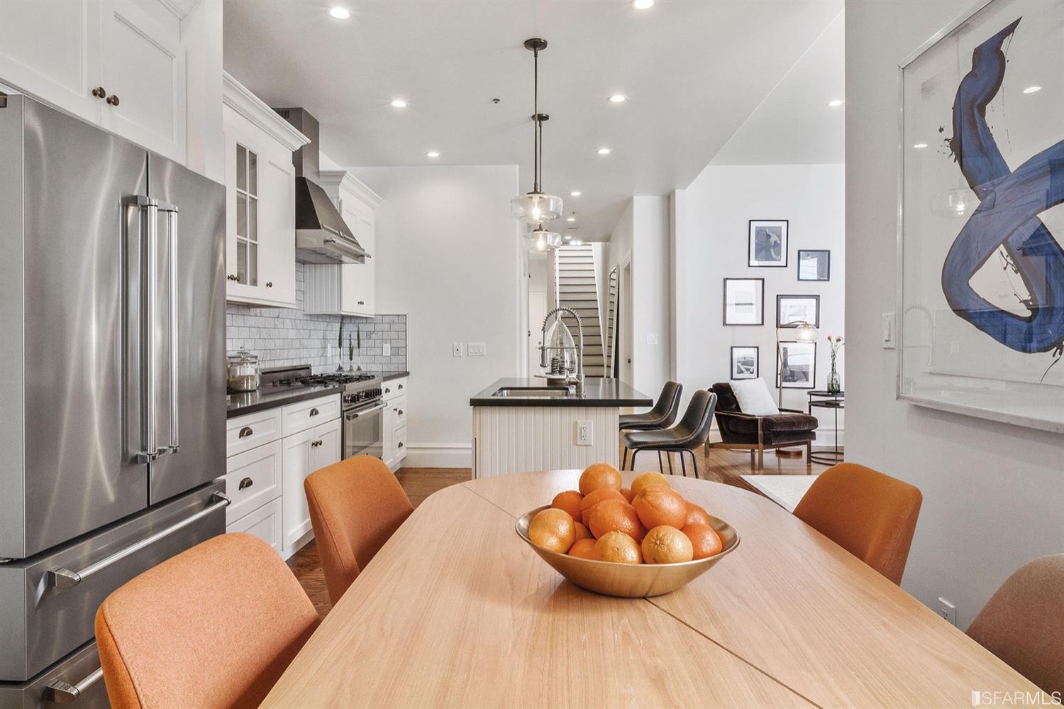 617 Broderick Street, Unit B San Francisco, CA 94117 - Photo 9 of 36 a kitchen with stainless steel appliances a refrigerator a sink dishwasher a dining table and chairs with wooden floor