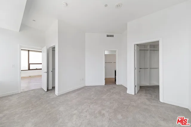 an empty room with closet area